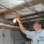Electrician checking light fixture