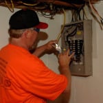 Electrician checking service panel
