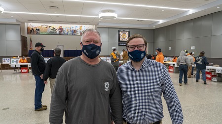 Two men in masks- IBEW Local 1 Business Representative Steve Muehling & St. Louis NECA Assistant Chapter Manager Kyle McKenna