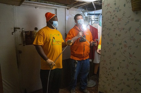 Electricians wearing masks, installing lighting