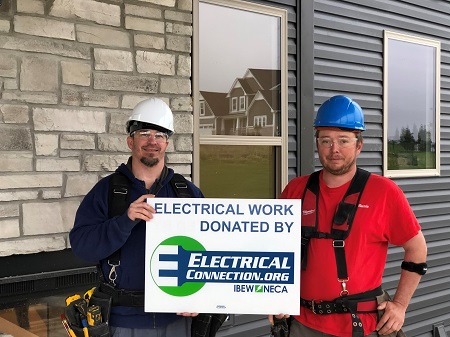 Electricians in hard hats holding sign with Electrical Connection logo