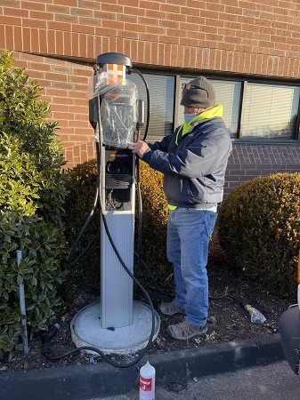 Man installing EV charging station