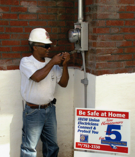 Electrician in hard hat working on a home